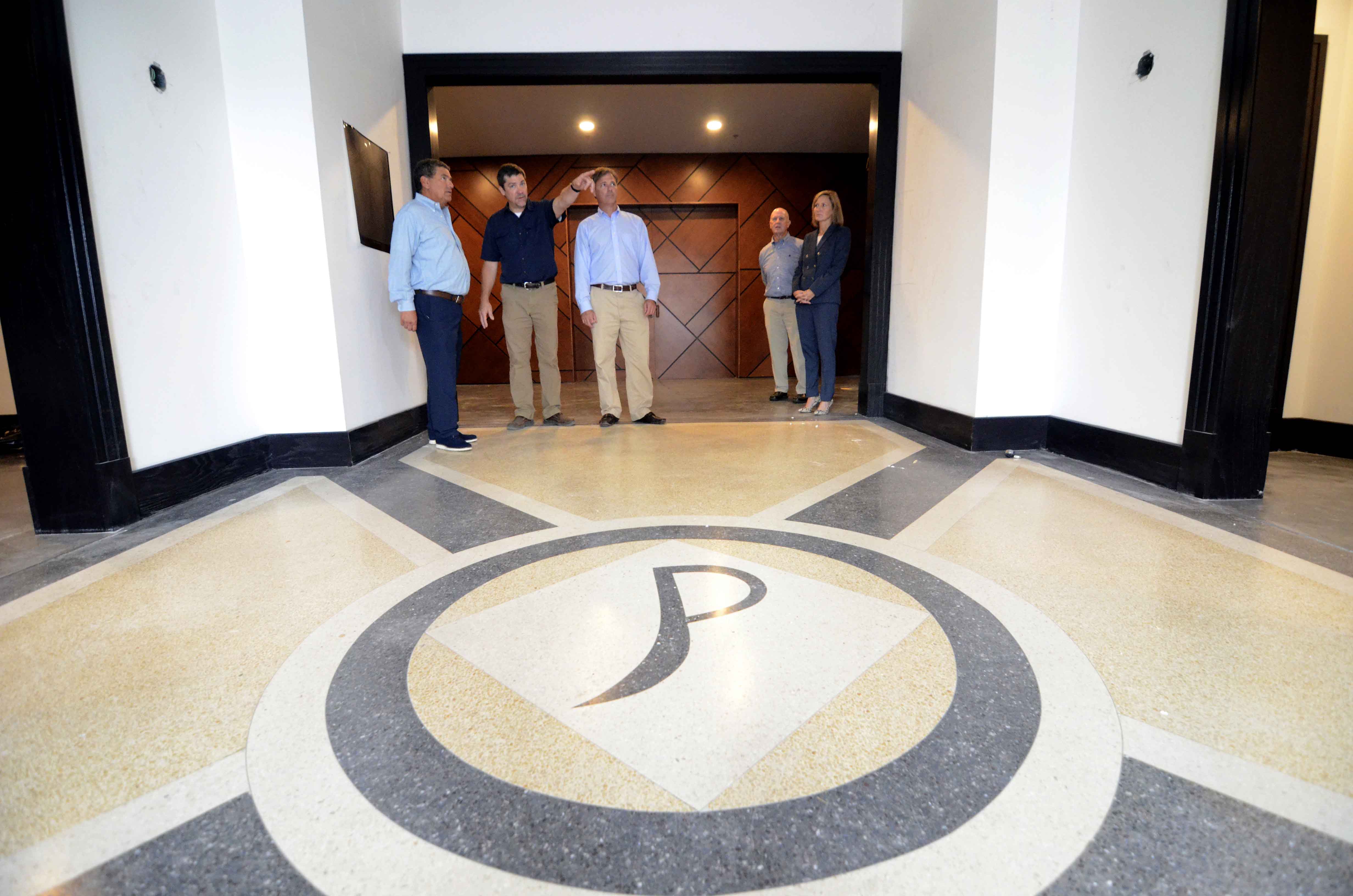 The theater's original logo has been preserved in the lobby floor. (Matt Williamson | Enterprise-Journal)