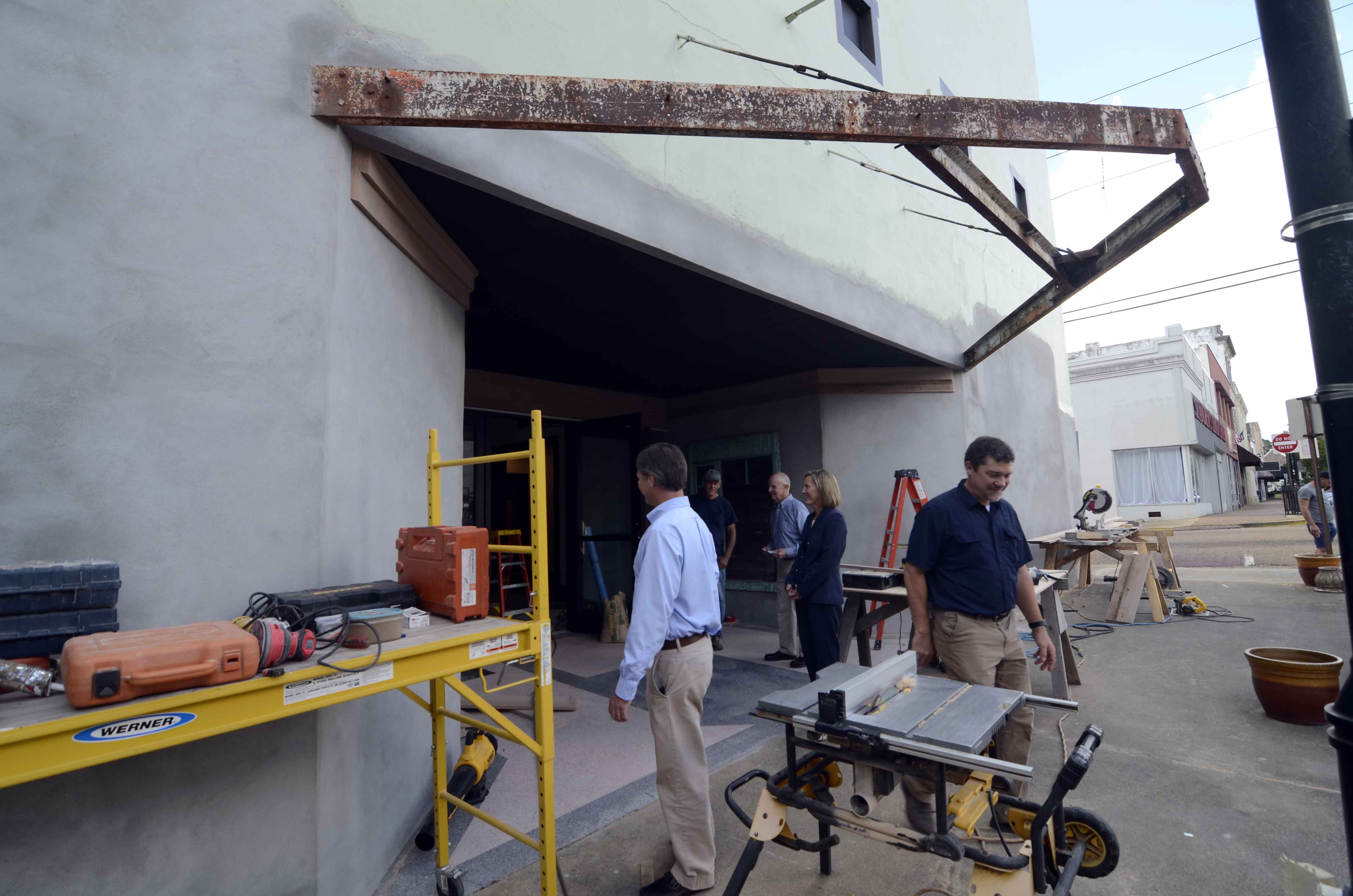 Hewitt and Van are seen outside the entrance to the Palace Theater, where the exterior belies the progress taking place inside. (Matt Williamson | Enterprise-Journal)