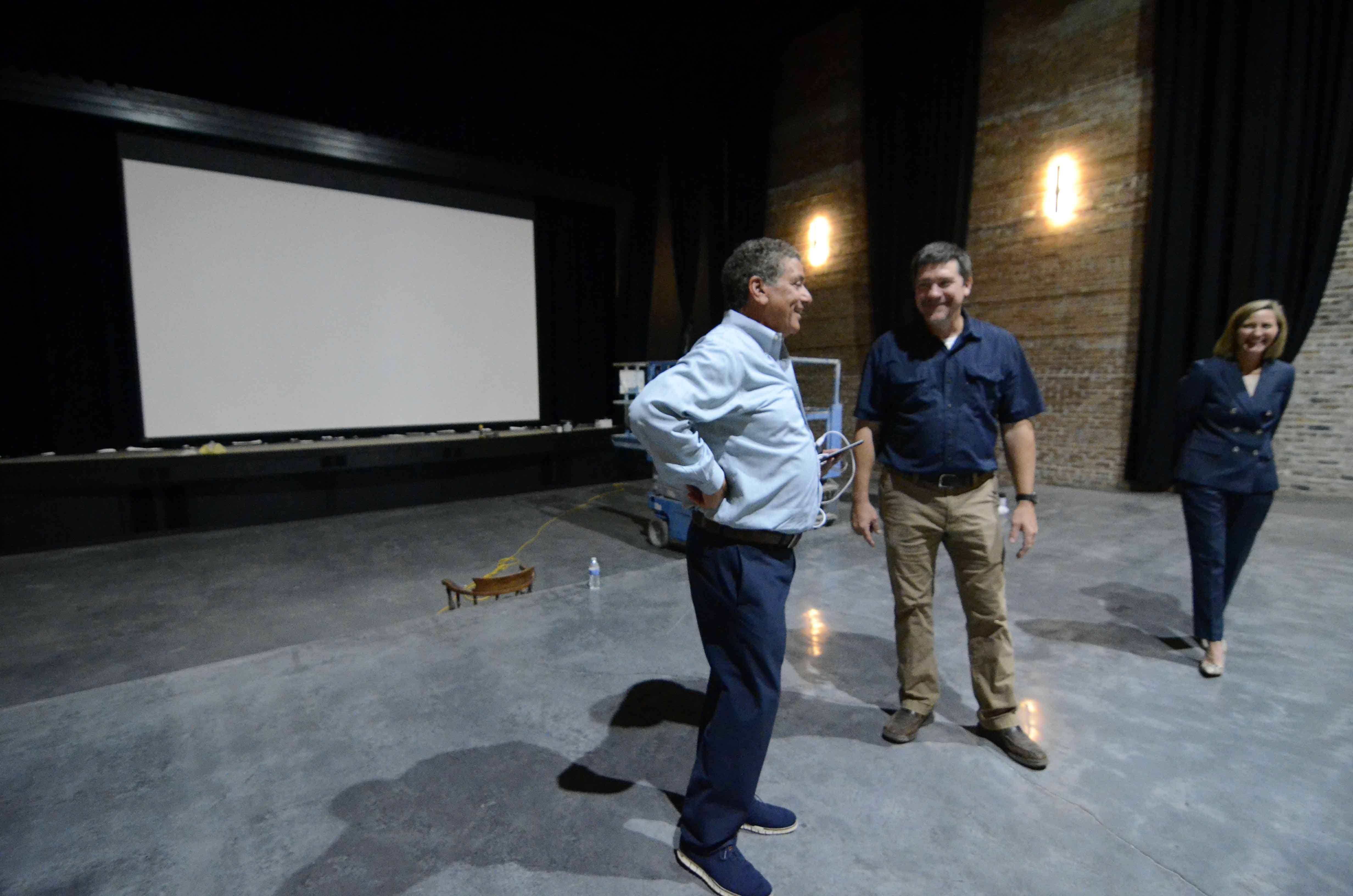 Gary Solomon looks around the Palace Theater with Jamey Hewitt and Leslee Brock. (Matt Williamson | Enterprise-Journal)