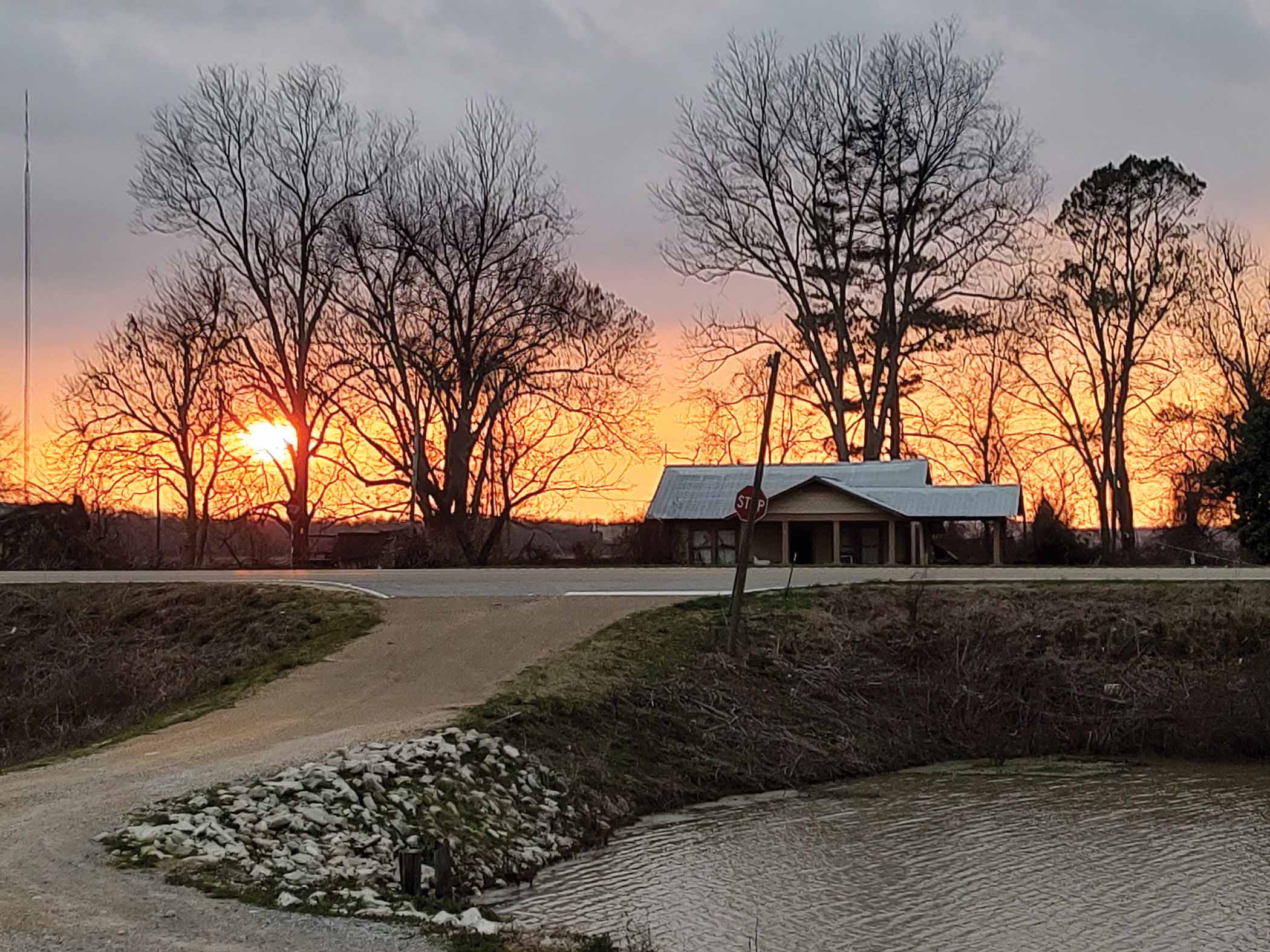 The sun sets beyond Highway 61 at Valley Park.