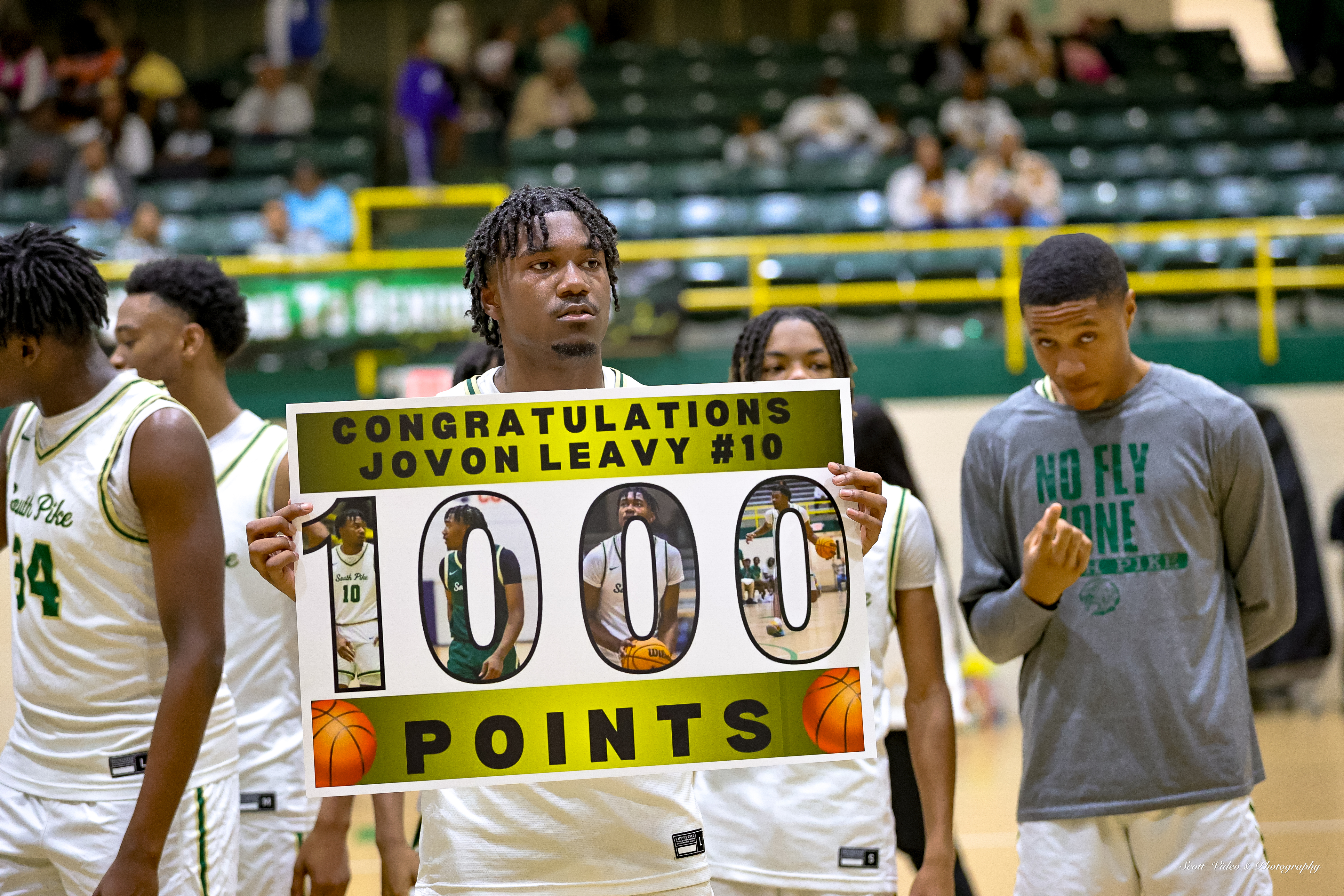 Jovon Leavy poses with his 1,000-point poster