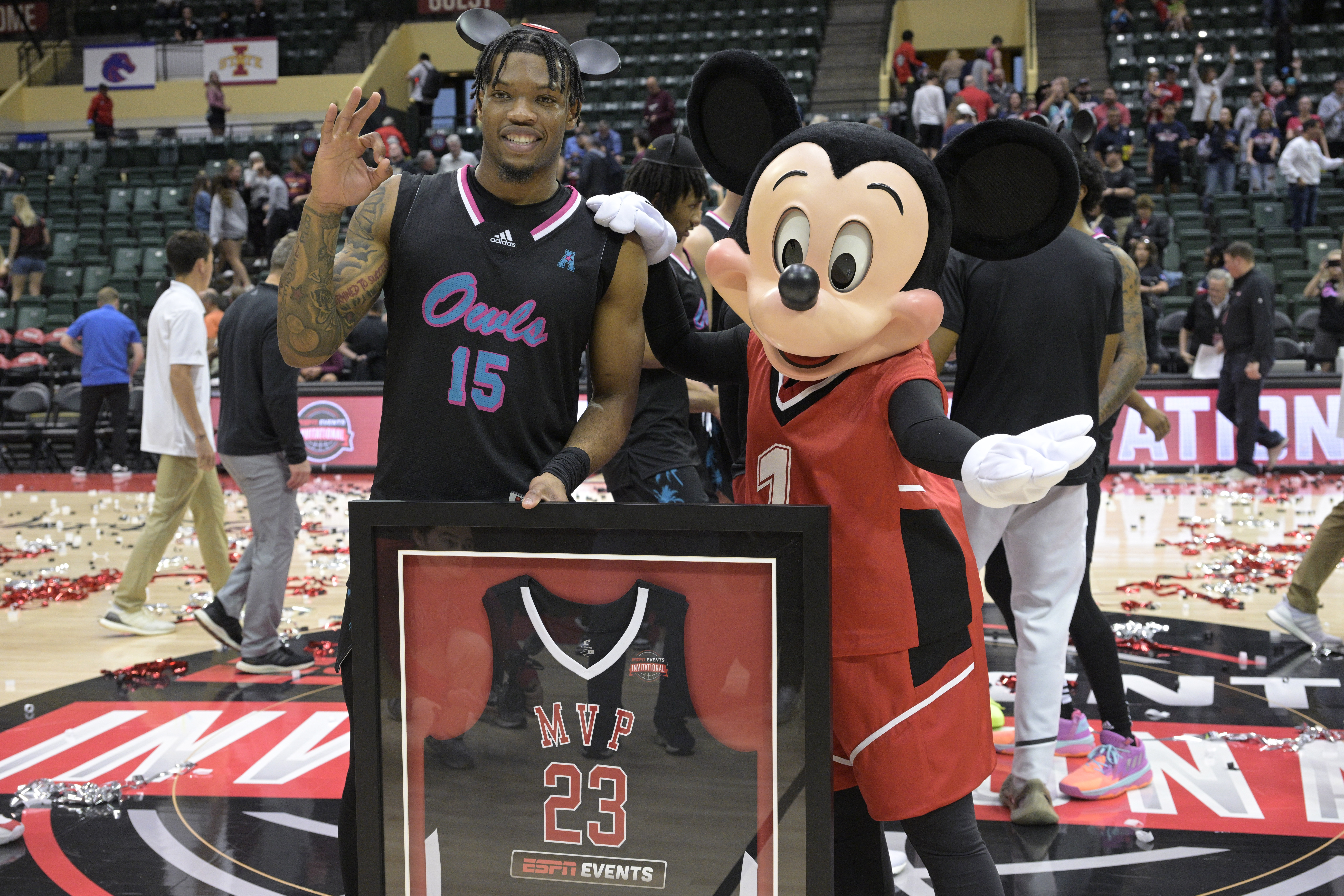 Florida Atlantic guard Alijah Martin poses with Mickey Mouse after being named the MVP of the ESPN Events Invitational in 2023.