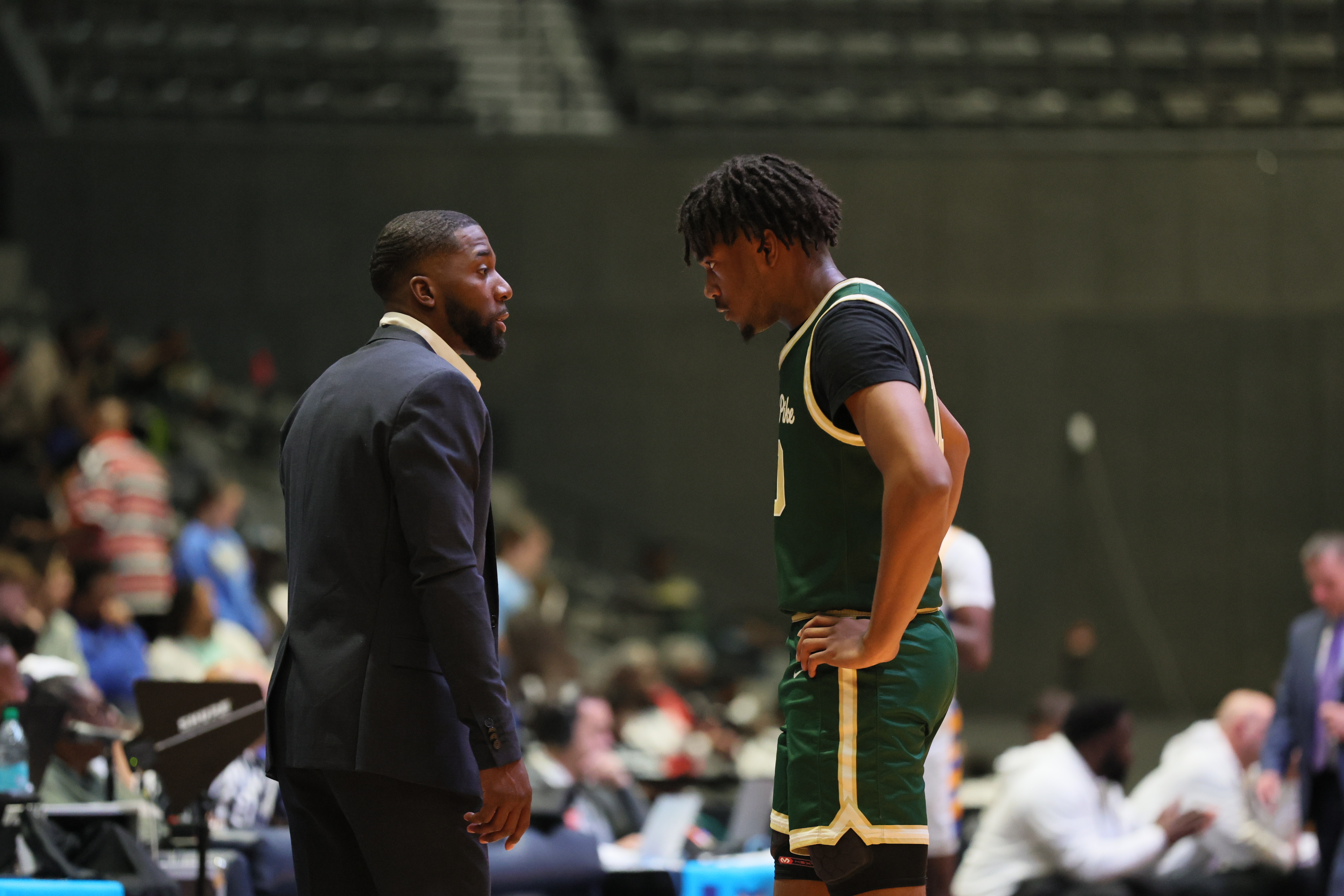 Reggie Chambers coaches up Jovon Leavy.
