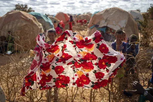 Children stand near shelters at a camp for displaced people on the outskirts of Dollow, Somalia, Sept. 19, 2022. (AP Photo/Jerome Delay, File)