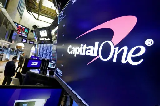 The logo for Capital One Financial is displayed above a trading post on the floor of the New York Stock Exchange, July 30, 2019. A federal jury on Friday, June 17, 2022, convicted a former Seattle tech worker of several charges related to a massive hack of Capital One bank and other companies in 2019. (AP Photo/Richard Drew, File)