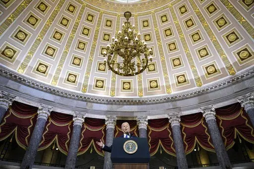 President Joe Biden delivers remarks on the one year anniversary of the January 6 attack on the U.S. Capitol, during a ceremony in Statuary Hall, Thursday,  Jan. 6, 2022 at the Capitol in Washington. (Drew Angerer/Pool via AP)