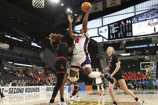 Mississippi forward Christeen Iwuala, front right, is fouled by Ball State forward Maliyah Johnson, left, as Ball State forward Marie Kiefer, right, looks on during the second half in the first round of the NCAA college basketball tournament, Friday March 21, 2025, in Waco, Texas. (AP Photo/Jerry Larson)