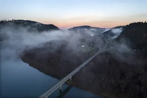 In this aerial image taken from a drone, the city of Klamath, Calif., home of the tribal headquarters for the Yurok Tribe, dots the side of U.S. Highway 101 at sunrise on Jan. 21, 2022. The Native American tribe has issued an emergency declaration on human trafficking and missing women. There have been five instances in the past 18 months where Indigenous women have gone missing or been murdered between San Francisco and the Oregon border. (AP Photo/Nathan Howard)