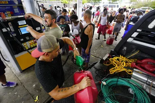 In the aftermath of Hurricane Ida, people wait in line for gas Tuesday, Aug. 31, 2021, in New Orleans, La. (AP Photo/Eric Gay)