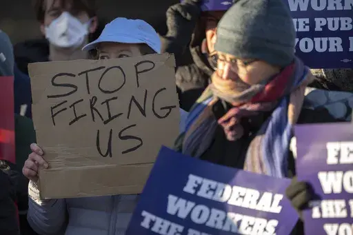 Demonstrators rally in support of federal workers outside of the Department of Health and Human Services, Feb. 14, 2025, in Washington. (AP Photo/Mark Schiefelbein, File)