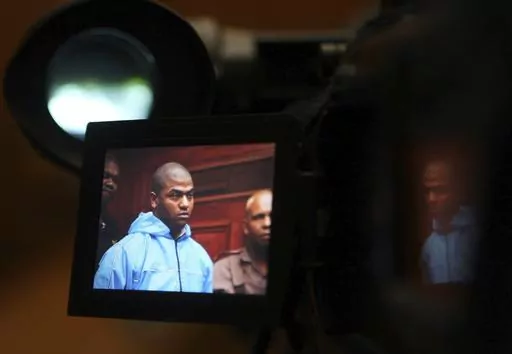 Thabo Bester is seen on a TV camera screen in the Western Cape High Court, in Cape Town, South Africa Thursday, May 3, 2012, where he appeared in connection with murder. The South African convicted murderer who faked his death to escape from prison has been arrested in Tanzania following a two-week manhunt, police have announced. South African officials are going to Tanzania Sunday April 9, 2023, to begin to extradite Thabo Bester. (AP Photo/Nardus Engelbrecht)