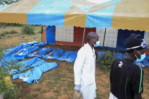 The exhumed bodies of victims of a religious cult are laid out in the village of Shakahola, near the coastal city of Malindi, in southern Kenya Sunday, April 23, 2023. Dozens of bodies have been discovered so far in shallow graves on land owned by a pastor Paul Makenzi in coastal Kenya who was arrested for telling his followers to fast to death. (AP Photo)