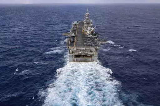 In this handout photo from the U.S. Navy, the Wasp-class amphibious assault ship USS Bataan travels through Atlantic Ocean on July 20, 2023. Thousands of Marines backed by the United States' top fighter jet, warships and other aircraft are slowly building up in the Persian Gulf. It's a sign that while America's wars in the region may be over, its conflict with Iran over its advancing nuclear program only continues to worsen with no solutions in sight. (Mass Communication Specialist 2nd Class Dan