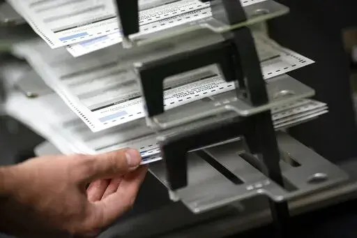 Poll workers sort out early and absentee ballots at the Kenosha Municipal building on Election Day, Nov. 3, 2020, in Kenosha, Wis.  Wisconsin’s conservative-controlled Supreme Court ruled Friday, July 8, 2022, that absentee ballot drop boxes may be placed only in election offices and that no one other than the voter can return a ballot in person, dealing a critical defeat to Democrats in the battleground state. (AP Photo/Wong Maye-E, File)