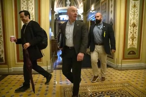 Homeland Security Secretary Alejandro Mayorkas, center, arrives for closed-door negotiations on a border security deal at the Capitol, Sunday, Dec. 17, 2023, in Washington. Negotiators are rushing to reach a U.S. border security deal that would unlock President Joe Biden's request for billions of dollars worth in military aid for Ukraine and national security. (AP Photo/Mark Schiefelbein)
