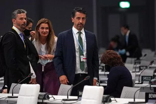 Joaquim Alvaro Pereira Leite, Brazil's Minister of the Environment gets to his feet after a plenary session during an interview at the COP26 U.N. Climate Summit in Glasgow, Scotland, Friday, Nov. 12, 2021. (AP Photo/Alberto Pezzali)