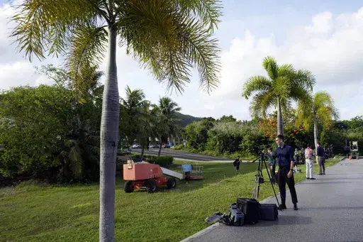 Journalists set up their camera to cover WikiLeaks founder Julian Assange who was brought to court to enter a plea deal, in Saipan, Mariana Islands, Wednesday, June 26, 2024. (AP Photo/Eugene Hoshiko)