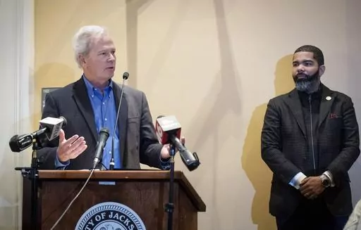 Ted Henifin, left, the City of Jackson water system third-party administrator, addresses media questions during a news conference at City Hall as Jackson Mayor Chokwe Antar Lumumba listens on Dec. 5, 2022, in Jackson, Miss. A District Court Judge said Tuesday, May 9, 2023, that he plans on placing Jackson's sewer system under the authority of Henifin, who was appointed in November to address the city's water troubles. The water system partially failed in August, and for days people had to wait i