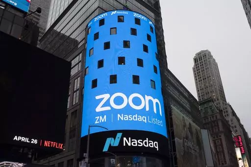 A display for Zoom Video Communications is shown ahead of the company's Nasdaq IPO in New York. An update to Zoom's terms of service in March 2023 have some online worried that the company is using their data to train artificial intelligence, without giving them the ability to opt out. But Zoom says that's false and online privacy experts agree, with some caveats. (AP Photo/Mark Lennihan, File)