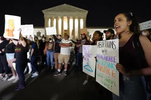 A crowd of people gather outside the Supreme Court, early Tuesday, May 3, 2022 in Washington. A draft opinion circulated among Supreme Court justices suggests that earlier this year a majority of them had thrown support behind overturning the 1973 case Roe v. Wade that legalized abortion nationwide, according to a report published Monday night in Politico. It's unclear if the draft represents the court's final word on the matter. The Associated Press could not immediately confirm the authenticit