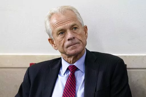 White House trade adviser Peter Navarro listens as President Donald Trump speaks during a news conference at the White House, on Aug. 14, 2020, in Washington. Former Trump adviser Navarro revealed in a draft court filing Tuesday, May 31, 2022, that he has been subpoenaed to appear before a grand jury this week as part of the Justice Department's sprawling probe into the deadly insurrection at the U.S. Capitol. (AP Photo/Patrick Semansky, File)