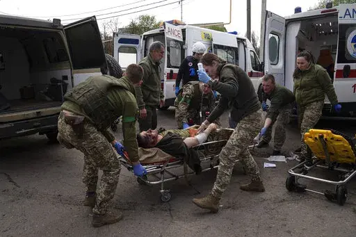 Ukrainian military medics move an injured Ukrainian serviceman to a hospital in Donetsk region, eastern Ukraine, Saturday, April 23, 2022. (AP Photo/Evgeniy Maloletka)