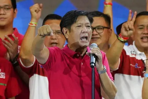 Presidential hopeful, former senator Ferdinand "Bongbong" Marcos Jr., the son of the late dictator, gestures as he greets the crowd during a campaign rally in Quezon City, Philippines on April 13, 2022. Marcos Jr.'s apparent landslide victory in the Philippine presidential election is giving rise to immediate concerns about a further erosion of democracy in the region, and could complicate American efforts to blunt growing Chinese influence and power in the Pacific. (AP Photo/Aaron Favila, File)