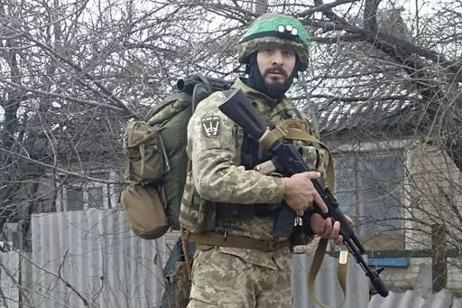 This 2023 photo provided by a 32-year-old professional soldier from Medellín, Colombia who goes by the call sign Checho shows him in his combat gear in Donbas, eastern Ukraine. Checho says he was struck by fire from a drone during a rescue operation to save a wounded colleague on the front line after three days of heavy fighting with Russian forces. At the hospital in the Kyiv region, Checho found himself with more than fifty other Colombians, most with light injuries sustained while fighting R