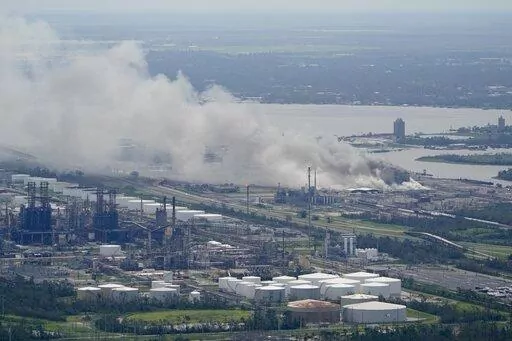 A chemical fire burns at a facility during the aftermath of Hurricane Laura, Aug. 27, 2020, near Lake Charles, La. The Securities and Exchange Commission moved closer Friday, June 17, 2022, to a final rule that would dramatically change what public companies tell shareholders about climate change. Companies would also have to disclose risks related to the physical impact of storms, drought and higher temperatures brought on by global warming.  (AP Photo/David J. Phillip, File)