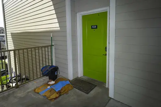 The front door of an apartment residence of former U.S. Marine Willy Joseph Cancel is shown Friday, April 29, 2022, in Murray, Ky.  Relatives say Cancel has been killed alongside Ukrainian forces in the war with Russia in what’s the first known death of an American citizen fighting in Ukraine.(AP Photo/John Amis)