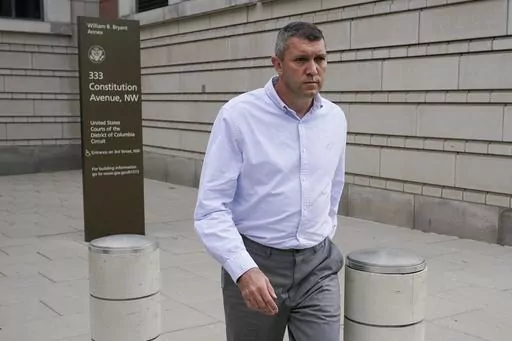 Washington Metropolitan Police Department Lt. Shane Lamond departs federal court after pleading not guilty to obstruction of justice and other charges, Friday, May 19, 2023, in Washington. Lamond is accused of lying about leaking confidential information to a leader of the far-right Proud Boys extremist group and obstructing an investigation after group members destroyed a Black Lives Matter banner in Washington. (AP Photo/Patrick Semansky)