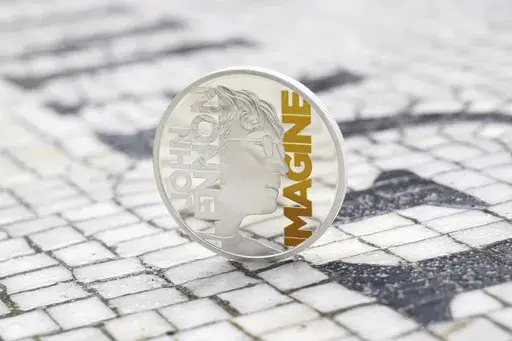 A specially minted British coin to mark the year the Beatles legend and peace advocate John Lennon is displayed in the Strawberry Fields section of Central Park, dedicated to the former Beatle, March 5, 2025, in New York. (Matt Crossick/PA Media Assignments via AP)