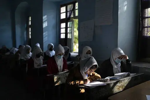 Afghan girls participate in a lesson at Tajrobawai Girls High School in Herat, Afghanistan on Nov. 25, 2021. In a surprise decision the hardline leadership of Afghanistan's new rulers has decided against opening educational institutions to girls beyond Grade six, a Taliban official said Wednesday, March 23, 2022 on the first day of Afghanistan's new school year. (AP Photo/Petros Giannakouris, File)