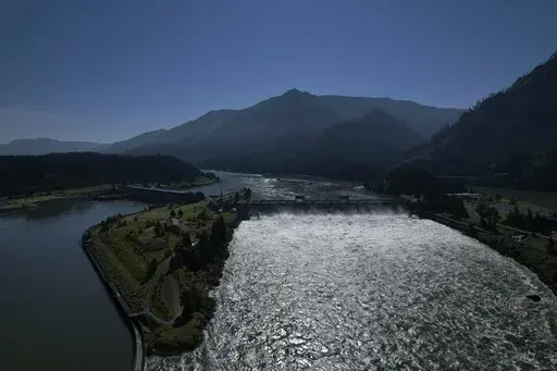 Water spills over the Bonneville Dam on the Columbia River, which runs along the Washington and Oregon state line, June 21, 2022. The U.S. and Canada said Thursday, July 11, 2024, that they have agreed to update a six-decade-old treaty that governs the use of one of North America’s largest rivers, the Columbia, with implications for electricity prices, irrigation, flood control and imperiled salmon runs. (AP Photo/Jessie Wardarski, File)