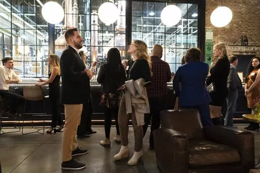 People mingle at a Philadelphia Distilling Daters Mixer Hosted by Date Him Philly, in Philadelphia, Tuesday, Nov. 14, 2023. Some of the most populous urban areas in the United States have an imbalanced sex ratio. Many of the largest counties along the Eastern Seaboard and in the Deep South skew female, while the largest urban counties in the West tilt male, according to data released this fall from the 2022 American Community Survey (AP Photo/Matt Rourke)