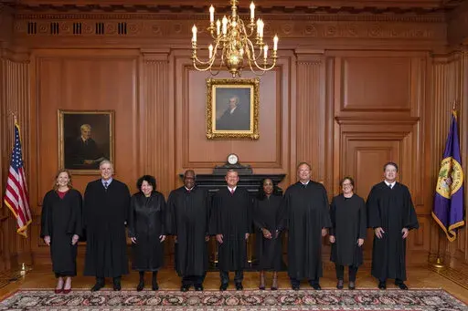 In this image provided by the Supreme Court, members of the Supreme Court pose for a photo during Associate Justice Ketanji Brown Jackson's formal investiture ceremony at the Supreme Court in Washington, Friday, Sept. 30, 2022. From left, Associate Justice Amy Coney Barrett, Associate Justice Neil Gorsuch, Associate Justice Sonia Sotomayor, Associate Justice Clarence Thomas, Chief Justice John Roberts, Associate Justice Ketanji Brown Jackson, Associate Justice Samuel Alito, Associate Justice Ele