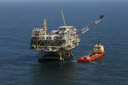 A rig and supply vessel are viewed in the Gulf of Mexico off the cost of Louisiana, April 10, 2011. A sale of federal Gulf of Mexico oil and gas leases that had been scheduled for Wednesday, Nov. 8, 2023, was delayed Thursday, Oct. 26, 2023, by a federal appeals court, pending court arguments that focus on protections for an endangered whale species. (AP Photo/Gerald Herbert, File)