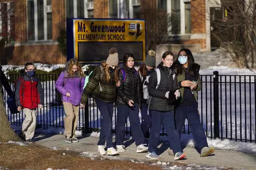 Students at the Mt. Greenwood Elementary School in Chicago depart after a full day of classes Monday, Jan. 10, 2022. As hundreds of thousands of Chicago students remained out of school for a fourth day students at the South Side school were back in classes as the school had enough staff to defy the union's directive to teachers to stay home amid negotiations with the school district over COVID-19 safety protocols. (AP Photo/Charles Rex Arbogast)