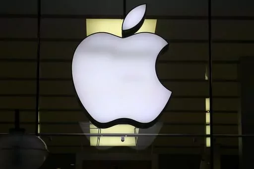 The Apple logo is illuminated at a store in the city center of Munich, Germany, Dec. 16, 2020. A potential redesign of two Apple Watch models, the Series 9 and Ultra 2, that would exclude the blood oxygen sensor has been approved by the U.S. Customs and Border Protection, according to a Monday, Jan. 15, 2024, court filing by Masimo, a Southern California company pursuing the patent claim. (AP Photo/Matthias Schrader, File)