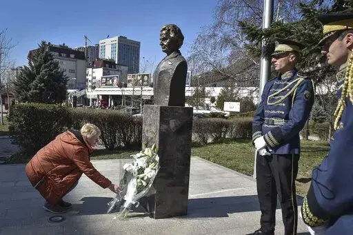 A woman lays a bouquet of flowers at the foot of a statue of former U.S. Secretary of State Madeleine Albright, in Pristina, Kosovo, Thursday, March 24, 2022. A monument in Kosovo, a snake named after her in Serbia. Madeleine Albright was either loved or hated in the Balkans for her pivotal role during the southern European region's wars of the 1990s. Following the former U.S. secretary of state's death on Wednesday at age 84, how her legacy is viewed from the Balkans mostly depends on whether o