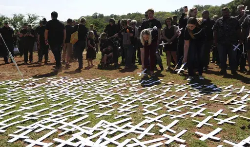 People place white crosses representing farmers killed in the country at a ceremony at the Vorrtrekker Monument in Pretoria, South Africa, Oct. 30, 2017. (AP Photo, File)