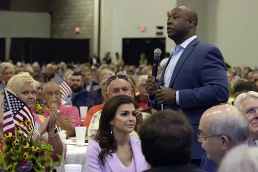 Republican presidential candidate Sen. Tim Scott, R-S.C., right, walks by Casey DeSantis, wife of GOP rival and Florida Gov. Ron DeSantis, center, as he speaks at Rep. Jeff Duncan's Faith & Freedom BBQ fundraiser on Monday, Aug. 28, 2023, in Anderson, S.C. Several campaigns are placing a huge emphasis on South Carolina, where the Republican primary is traditionally the last chance for many White House hopefuls to break through before Super Tuesday. (AP Photo/Meg Kinnard, File)