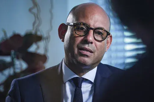 Simon Stiell sits for an interview to discuss his new role as the executive secretary of the U.N. Framework Convention on Climate Change, Thursday, Sept. 22, 2022, at U.N. headquarters. Stiell was the environment and climate resilience minister on the small island nation of Grenada until a few weeks ago. It’s now his job to make sure the world cuts about half emissions of heat-trapping gases — which are helping trigger unprecedented frequent weather disasters — in just eight years, or, as 