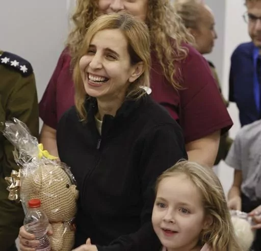 Danielle Aloni laughs next to her daughter Emilia Aloni as they meet family members at the Schneider Children's Medical Center, Israel, Saturday, Nov. 25, 2023. Danielle Aloni and her 5-year-old daughter Emilia had been seized from a kibbutz by Hamas in its Oct. 7 rampage into southern Israel. Nutthawaree Munkan, a Thai agricultural worker, was abducted the same day. The three became close during their seven weeks' captivity in Gaza. (Schneider Children's Medical Center Spokesperson via AP)