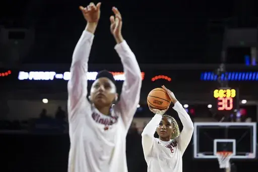 Southern California forward Kiki Iriafen, right, warms up behind guard JuJu Watkins, left, before a game against Mississippi State in the second round of the NCAA college basketball tournament Monday, March 24, 2025, in Los Angeles. (AP Photo/Jessie Alcheh)