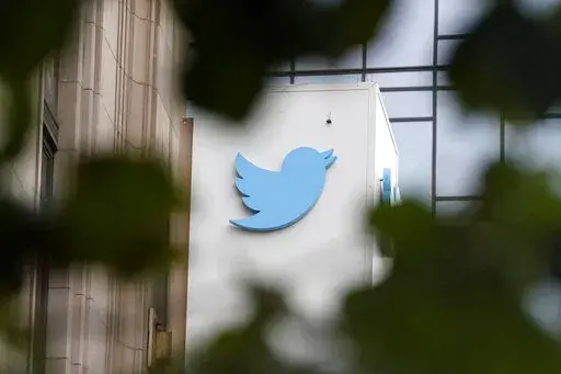 A sign at Twitter headquarters is shown in San Francisco, Thursday, Dec. 8, 2022. Twitter has suspended an account that used publicly available flight data to track Elon Musk's private jet, despite a pledge by the social media platform's new owner to keep it up because of his free speech principles. (AP Photo/Jeff Chiu, File)