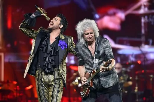 Adam Lambert, left, and Brian May of Queen + Adam Lambert perform in Chicago on Aug. 9, 2019. The band is hitting the road this fall for a North American expansion of their Rhapsody Tour. The tour will make 14 stops throughout the U.S. and Canada, including shows in New York, Boston, Toronto, Chicago, Nashville and Dallas, before closing out at Los Angeles in November. (Photo by Rob Grabowski/Invision/AP, File)