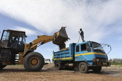 Sand is loaded into a truck at Seroma Ltd. sand mine on April 5, 2023, in the Lwera wetlands near Lukaya, Uganda. The wetland has long been worked over by sand miners, both legal and illegal. Now, all known corporate operations within the wetland have authorization to be there, giving them a measure of legitimacy that's frustrating environmental activists. (AP Photo)
