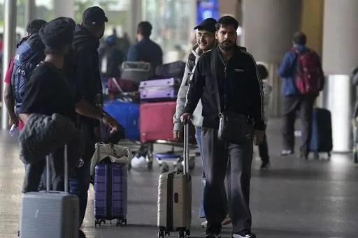 Indian passengers who travelled in an unmarked Legend Airlines A340 from Vatry Airport in France, arrive at the Chhatrapati Shivaji Maharaj International Airport in Mumbai, India, Tuesday, Dec. 26, 2023. A charter plane that was grounded in France for a human trafficking investigation arrived in India with 276 Indians aboard early Tuesday, authorities said. The passengers had been heading to Nicaragua but were instead blocked inside the Vatry Airport for four days in an exceptional holiday ordea