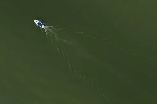 A boat motors through Lake Erie during an algal bloom, Monday, Aug. 26, 2024, at Maumee Bay State Park in Oregon, Ohio. (AP Photo/Joshua A. Bickel)